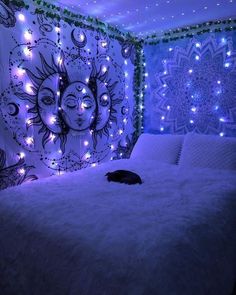 a cat is laying on a bed in a room decorated with lights