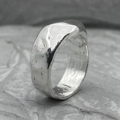 The liquid Ring Processing Type: Volcanic oxidation+Polishing Width 6-7 mm Weight about 8-9g (depends on size) Description: The wide band of silver resembles liquid metal. The glossy texture becomes matte over time and acquires a unique texture that reflects the character of its owner. It is ideal for daily wear. This ring can be a great choice for engagement rings if you want something minimal and stylish. My wife and I chose just such a texture for our wedding rings, and it is interesting for Mens Silver Bangle, Chunky Silver Rings, Wax Carving, Liquid Metal, Hammered Rings, How To Make Rings, Textured Ring, Mens Silver Rings, Men's Rings