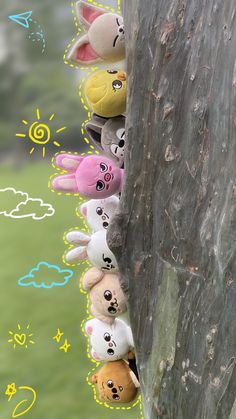 several stuffed animals are lined up on a tree