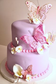 there is a purple cake with butterflies on it