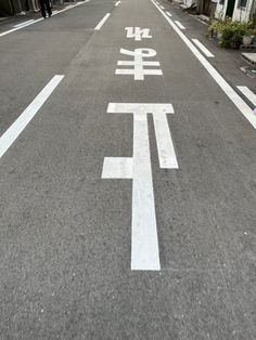 an empty street with chinese writing painted on it