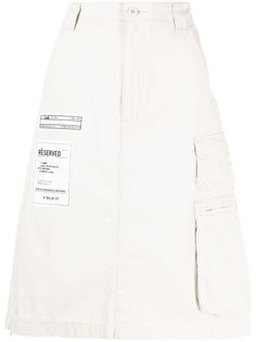 light beige cotton logo patch to the side patch detail belt loops rear elasticated waistband side cargo pocket slip pockets to the sides two rear flap pockets front button and zip fastening knee-length White Cotton Cargo Skirt With Pockets, Beige Cotton Cargo Skirt With Pockets, Beige Utility Cargo Skirt With Side Pockets, Beige Cargo Skirt With Utility Style, Beige Utility Cargo Skirt, Utility Beige Cargo Skirt With Side Pockets, Cargo Pocket, Cotton Logo, Cotton Skirt