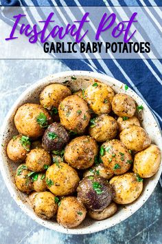 a white bowl filled with potatoes and parsley on top of a blue table cloth