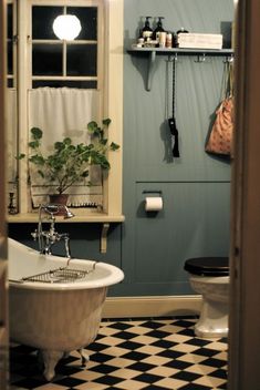 a bathroom with a checkered floor and black and white tile