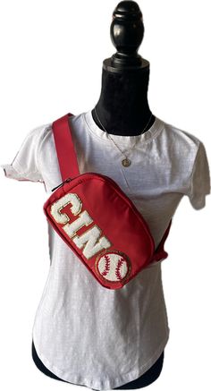 Cincinnati Reds Baseball Inspired Cross Body Bag/Belt Bag/Shoulder Bag. Stadium Approved Size Our Spirit Bag has a multi use strap with buckle closure allowing the bag to be used as a crossbody, fanny pack or shoulder bag. It is roomy for its compact size with a zipped pocket on the back and mesh pockets on both sides inside; one full pocket on one side and two smaller pockets on the other side. Each bag is crafted from lightweight nylon that makes it both waterproof and easy to clean. All added Red Crossbody Belt Bag With Adjustable Strap, Red Adjustable Strap Crossbody Belt Bag, Red Casual Belt Bag With Adjustable Strap, Casual Red Belt Bag With Adjustable Strap, Spirit Bags, Crossbody Fanny Pack, Cincinnati Reds Baseball, Reds Baseball, Bag Belt