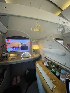 the inside of an airplane that is full of items and has a laptop on it