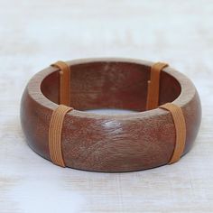 Arti Sharma of India presents an attractive babul acacia wood bangle bracelet. The bracelet's smooth finish highlights the wood grain and four bands of brown cotton cord wrapped around the bangle give it a distinctive look. Cord Wrap, Wood Bracelet, Buy Wood, Bracelet Charm, Women Artisans, Cotton Cord, Jewelry Packaging, Acacia Wood, Jewelry Gift Box