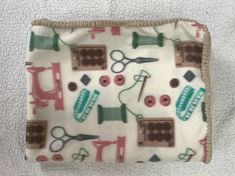 a close up of a cloth with sewing related items on it