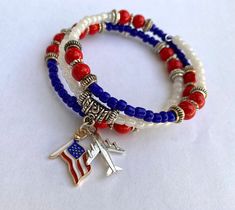 Introducing our Patriotic Wrap Bracelet, a captivating homage to freedom and adventure! Meticulously crafted, this bracelet showcases vibrant red, white, and blue beads, symbolizing the unity and pride of the American spirit. Adorned at its center are charming accents: a miniature airplane and an American flag charm, embodying the essence of patriotism and wanderlust. Wear this bracelet proudly on any occasion, adding a touch of patriotic elegance to your ensemble or gifting it to a fellow patriot. Order yours today and celebrate the land of the free and the home of the brave with sophistication and style! Blue Friendship Bracelets For 4th Of July Gift, Patriotic Blue Friendship Bracelets As Gift, Patriotic White Jewelry For 4th Of July, Red American Flag Jewelry For Independence Day, Patriotic Adjustable Friendship Bracelets, Adjustable Patriotic Friendship Bracelets, Patriotic Blue Friendship Bracelets, Patriotic Blue Friendship Bracelet, Patriotic Round Beads Stretch Bracelet For 4th Of July