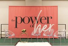 three clear chairs sitting in front of a pink sign that says the power of beer