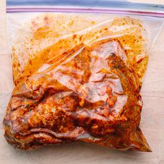 a bag filled with meat sitting on top of a wooden table