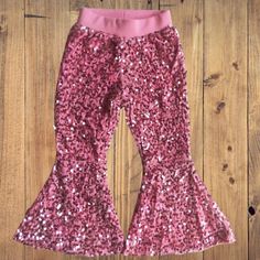 Includes: Bell Bottoms Only Care instructions: Turn inside out. Machine was cold and tumble dry low Stretch Sequined Bottoms For Fall, Spring Glitter Stretch Bottoms, Holiday Stretch Sequin Bottoms, Fitted Glitter Bottoms For Spring, Pink Stretch Bottoms For Winter, Pink Sequined Bottoms For Spring, Fitted Sequin Bottoms For Winter, Stretch Pink Sequined Pants, Sequin Bell Bottoms