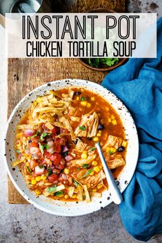 instant pot chicken tortilla soup in a white bowl on a wooden table with a blue napkin