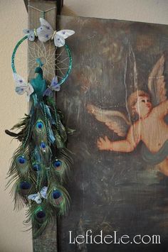 a painting and peacock feathers are hanging on the wall