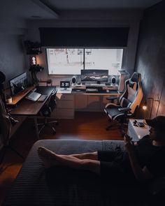 a bedroom with a bed, desk and computer