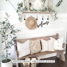 a wooden bench sitting next to a potted plant on top of a hard wood floor