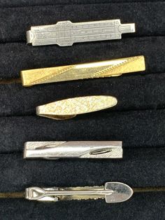 Lot of 5 tie clips 1. silver ruler 2. gold bar 3. gold oval 4. silver bar 5. silver shovel Please look at the photos carefully as they are major part of the product description.  These show sign of use, slight scratches,  but are still very useable. International Buyers Please Note: ... Import duties, taxes and charges are not included in the item price or shipping charges. These charges are the buyer's responsibility and cannot be held responsible for delays in shipping or customs. Please check with your country's customs office to determine what these additional costs will be prior to bidding/buying. Thanks for shopping EVHBAG Etsy Shop and enjoying our vintage items. We are happy to answer any questions about this item. All items guaranteed to be vintage. Returns are welcome. Lingot D'or, Vintage Tie, Silver Bar, Tie Clips, Tie Tack, Silver Bars, Gold Bar, Tie Accessories, Suit And Tie