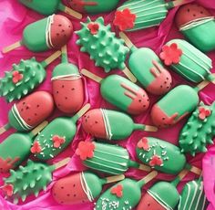 green and red decorated cookies on pink paper