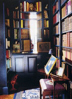 a room filled with lots of books next to a window