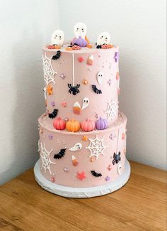 a three tiered cake decorated with halloween decorations