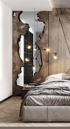 a bedroom with a bed, mirror and lights on the headboard is pictured in this image