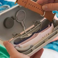 a person is holding an electronic device in their hand and it's inside the case