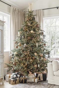 a decorated christmas tree with presents under it