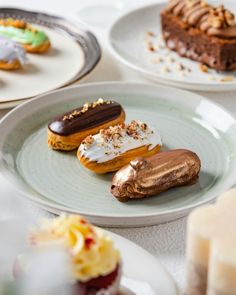 four different types of pastries on plates