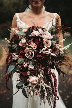 a woman holding a bouquet of flowers in her hands