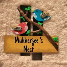 there is a sign that says mukherge's nest with two birds on it