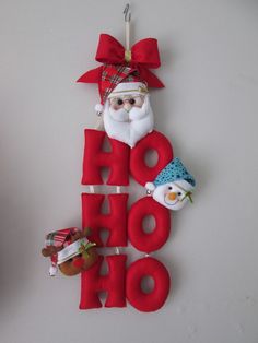 a christmas ornament hanging on the wall with santa claus and snowman decorations