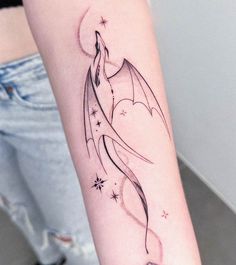 a woman's arm with a dragon tattoo on the left side of her body