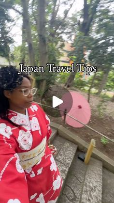 a woman in a red kimono standing on steps