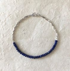 Lapis lazuli, Karen Hill Tribe Thai silver beaded stacking bracelet 7 inches is average size Lapis Lazuli metaphysical properties: Inner truth, inner power, love, purification, intuition, self-confidence, manifestation, friendship Can be custom made with any gemstone Please note Gemstones are works of nature, therefore, can have differences in color and may have inclusions. Because of this, your piece may vary slightly from what is pictured. Thai Silver or Karen Hill Tribe Silver are all complet Adjustable Lapis Lazuli Beaded Bracelet With Faceted Beads, Adjustable Beaded Sapphire Bracelets, Blue Bracelets With Tiny Beads For Parties, Adjustable Beaded Sapphire Bracelet, Adjustable Faceted Sapphire Bracelets, Bohemian Blue Rondelle Bracelets, Adjustable Faceted Sapphire Bracelet, Blue Beaded Rondelle Crystal Bracelet, Blue Faceted Beads Bangle Jewelry