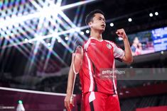 a man standing on top of a basketball court holding a racquet in his hand