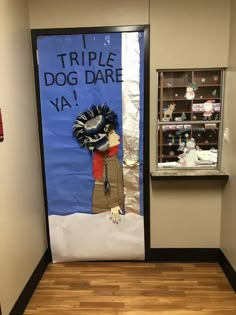 a door decorated with an image of a dog in the snow and words that read triple dog dare ya