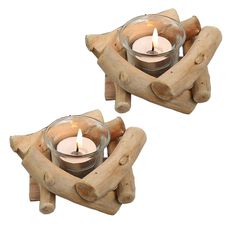 two small candles are placed in the shape of log holders, with one candle lit inside