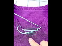 someone is stitching the thread on a sweater