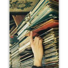 a person reaching for records on a shelf