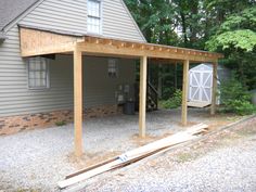 a house with a covered patio in front of it and a shed next to it