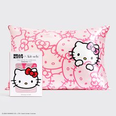 the hello kitty pillow is next to its packaging