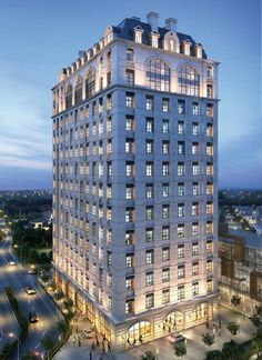 a large white building with lots of windows on top of it's sides at night