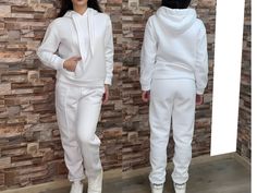 FREE EXPRESS SHIPPING for all United State orders over $35* Two Piece Tracksuit Outfit with Hoodie and Pockets / Two Piece Athletic Set / Аthletic Wear / Athletic Pants / Athletics Hoodie Three-piece set. High-waisted trousers with built-in elastic. Side pockets and wide legs. Impressive crop top with short sleeves and a round neckline. Comfortable blouse with a loose silhouette. Wide, loose sleeves and turtleneck. Asymmetric hem. Materials: cotton This dress is perfect for different events, parties, dinners and hangouts. ♥ THE PERFECT GIFT FOR YOUR LOVED ONE ♥ ♥ All garments are handmade in our little Boutique in a special UNIQUE way ♥ Different sizes available. Check the listing for your size. * SOME PLUS SIZES ARE ALSO AVAILABLE SIZE CHART How to measure yourself * Bust: * Use a flexibl Fitted White Tracksuit For Gym, White Stretch Tracksuit For Sportswear, White Winter Gym Tracksuit, White Winter Activewear For Jogging, Winter White Jogging Activewear, White Tracksuit With Pockets For Sports, White Drawstring Hood Sweats For Sportswear, White Drawstring Hood Sweats Sportswear, White Drawstring Hood Sweats