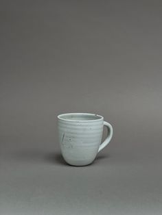 a white cup sitting on top of a table