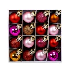 twelve christmas baubles in a box with gold, red and purple ornaments on them