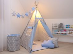 a child's teepeet with stars on the ceiling and pillows around it