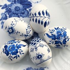 blue and white painted eggs on a plate