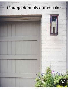 a fire hydrant sitting next to a white brick building with a light on it