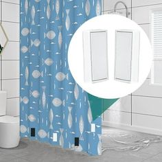 a bathroom with a blue shower curtain next to a toilet