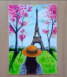 a painting of the eiffel tower with a woman's hat on her head